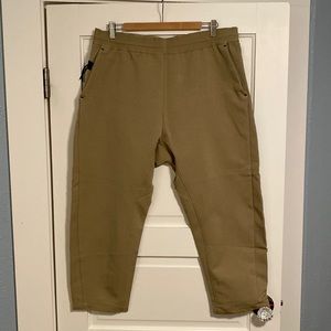 2 Nike Sportswear tech pants. 1 beige and 1 cool gray. Both are men’s X-LARGE.